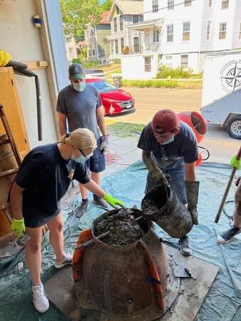 Anja Nikkel, Pete Solomon, Vincent Brandi making reef balls. Image courtesy of James Nikkel.