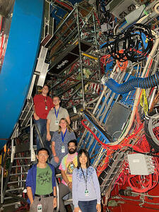 People standing on staircase in front of equipment